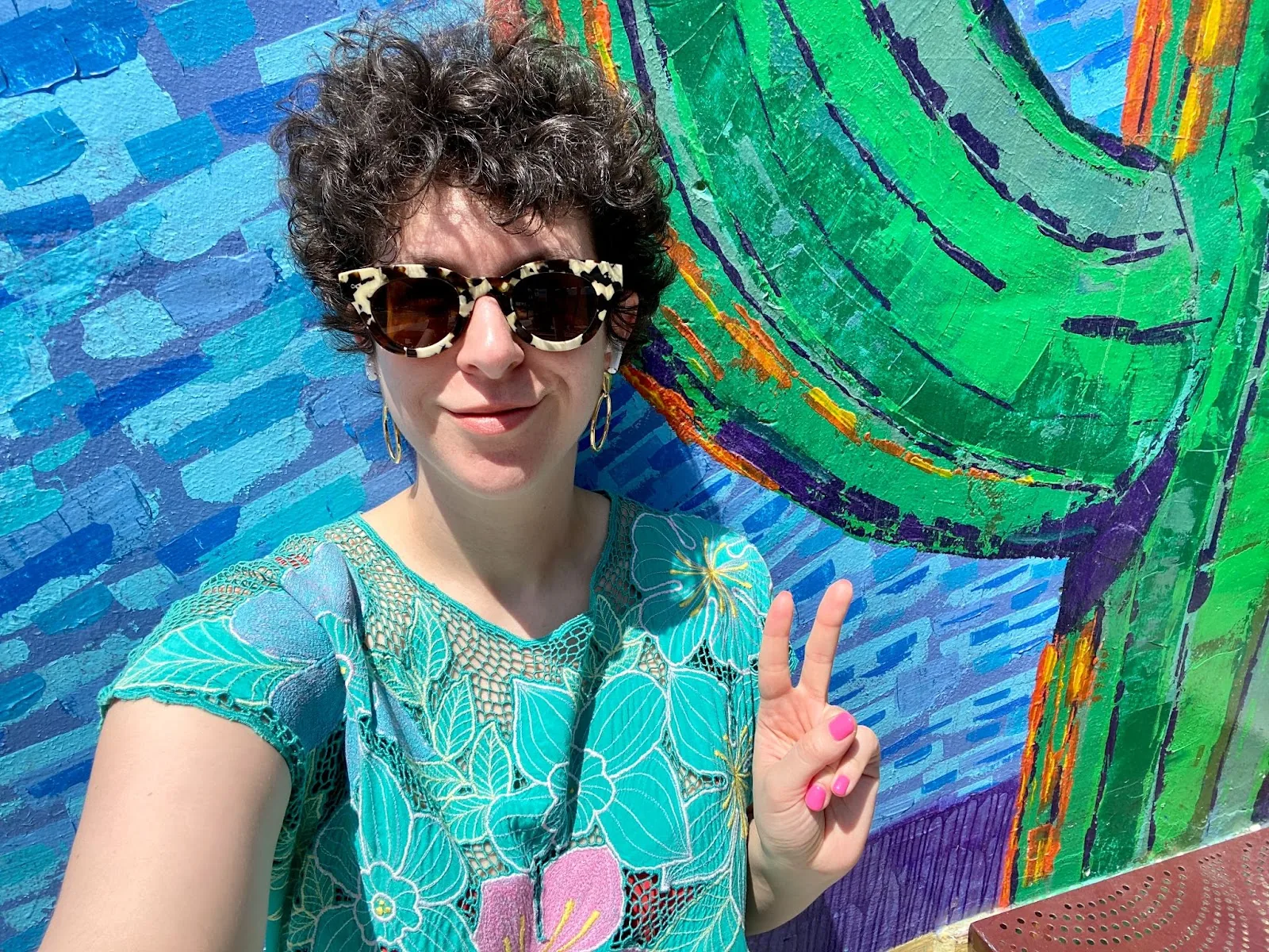 Molly wears a vintage 1980s turquoise floral dress.